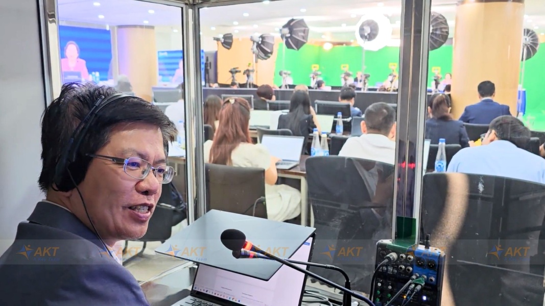 AKT interpreter performing simultaneous interpreting in a booth at a listed company's Annual General Meeting